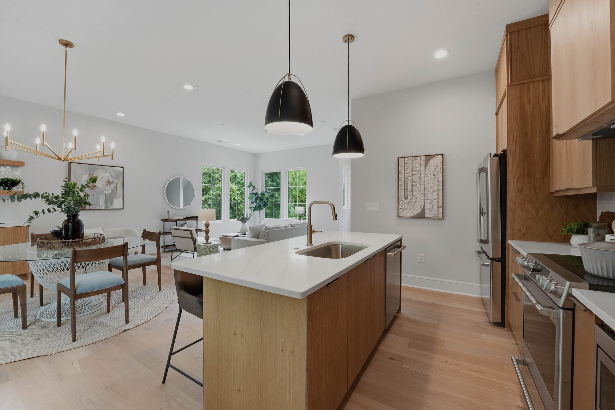 Kitchen at 604 E 16th Street: white oak cabinets and floors, Visual Comfort pendants, Café appliances